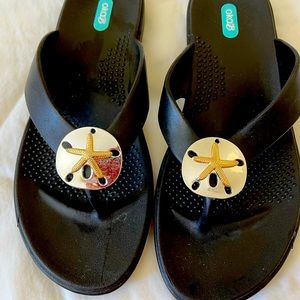 Oka B Flip Flop Sandals with silver sand dollar adornment.